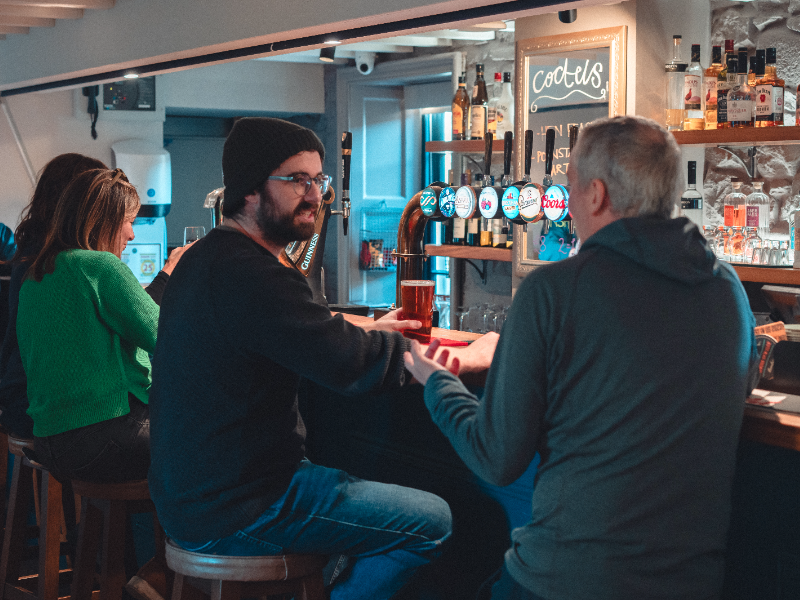 Two men sitting at the bar, chatting
