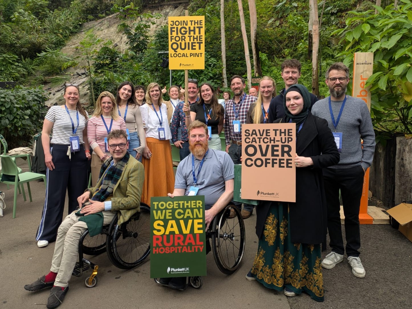 17 Plunkett supports pose for a photograph in solidarity, holding placards such as 'Together we can save rural hospitality'