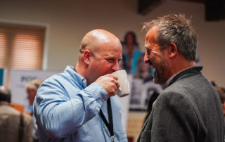 delegates laugh over coffee